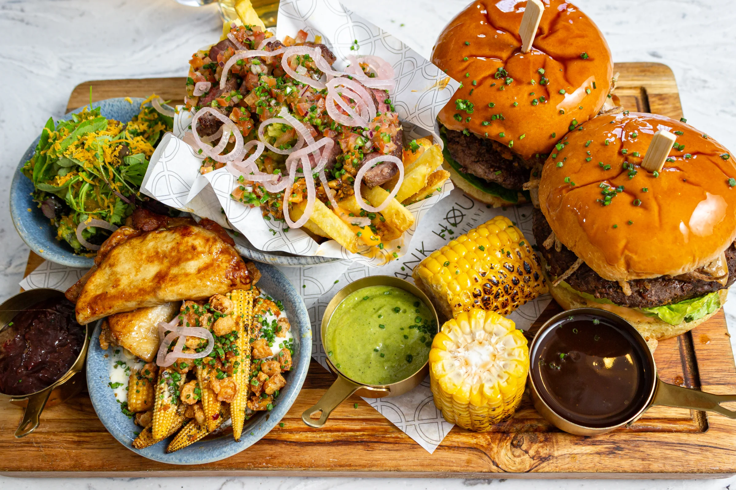 Mexican-inspired sharing board with burgers, tacos and corn elotes at Bank House Hathersage