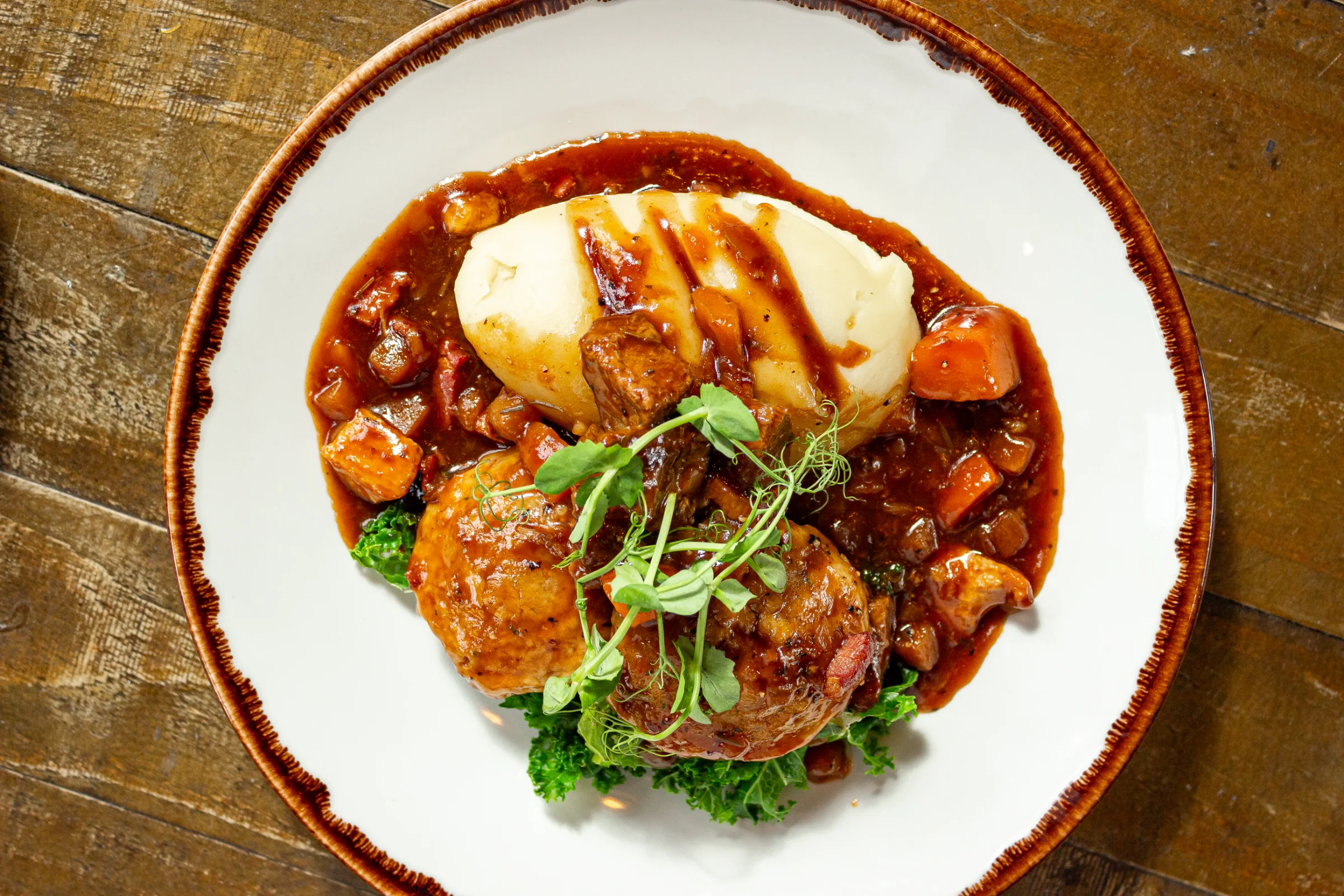 A hearty homemade stew with potato mash and dumplings at The Little John Hathersage